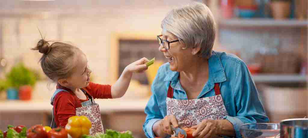 Granddaughter Feeding Grandmother Celery